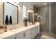 Bathroom with double vanity, modern fixtures, large mirrors, and walk in shower at 6858 E Orion Dr, Scottsdale, AZ 85257