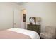 Bright bedroom featuring a charming chair, accent cabinet, and stylish decor at 6858 E Orion Dr, Scottsdale, AZ 85257