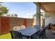Charming covered patio with dining set, modern privacy screen, and lush landscaping at 6858 E Orion Dr, Scottsdale, AZ 85257