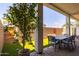 Charming covered patio with outdoor dining set, lush greenery, and brick flooring at 6858 E Orion Dr, Scottsdale, AZ 85257