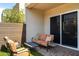 Inviting covered patio with a sofa, chairs, decorative pillows, and privacy wall at 6858 E Orion Dr, Scottsdale, AZ 85257