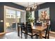 Dining room with modern light fixture, leading to outdoor patio through sliding glass door at 6858 E Orion Dr, Scottsdale, AZ 85257