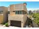 Modern two-story home with stone accents, a dark garage door, and neatly landscaped front at 6858 E Orion Dr, Scottsdale, AZ 85257