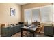 Dedicated office space with a large window, custom cabinets, and a spacious desk at 6858 E Orion Dr, Scottsdale, AZ 85257