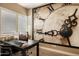 Bright office space featuring a large clock art piece and a wooden desk with dual monitors at 6858 E Orion Dr, Scottsdale, AZ 85257