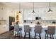 Modern kitchen with long island, stainless steel appliances, pendant lighting, and luxury finishes at 6858 E Orion Dr, Scottsdale, AZ 85257