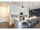 Modern kitchen with stainless steel appliances, white cabinetry, and a large island with bar seating at 6858 E Orion Dr, Scottsdale, AZ 85257