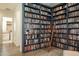 Spacious home library with floor-to-ceiling bookshelves and hardwood floors at 6858 E Orion Dr, Scottsdale, AZ 85257
