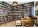 Cozy library featuring extensive bookshelves, comfortable seating, and a warm ambiance at 6858 E Orion Dr, Scottsdale, AZ 85257