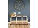 Console table with decor set against a blue wall at 6858 E Orion Dr, Scottsdale, AZ 85257