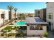 Stylish community pool area with palm trees, lounge chairs, and a covered outdoor kitchen at 6858 E Orion Dr, Scottsdale, AZ 85257
