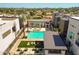 Aerial view of a modern community pool, surrounded by stylish patio furniture and lush landscaping at 6858 E Orion Dr, Scottsdale, AZ 85257