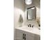 Chic powder room with decorative tile backsplash, floating vanity, bronze hardware, and modern fixtures at 6858 E Orion Dr, Scottsdale, AZ 85257