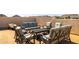 Expansive rooftop patio with stylish seating, a dark table, and stunning city and mountain views at 6858 E Orion Dr, Scottsdale, AZ 85257