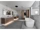 Spacious bathroom with double vanity, soaking tub, wood cabinets and marble counters at 7014 E Palo Verde Ln, Paradise Valley, AZ 85253