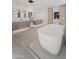Elegant bathroom featuring a soaking tub, dual vanities, and stylish light fixtures at 7014 E Palo Verde Ln, Paradise Valley, AZ 85253