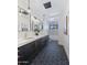 Modern bathroom featuring dual sinks, stylish black and gold fixtures, and decorative tile at 7014 E Palo Verde Ln, Paradise Valley, AZ 85253