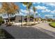 Modern home with a brick driveway, dark siding, well-maintained landscaping, and mature trees at 7014 E Palo Verde Ln, Paradise Valley, AZ 85253