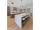 Modern kitchen featuring double islands, a breakfast bar, stainless steel appliances, and hardwood floors at 7014 E Palo Verde Ln, Paradise Valley, AZ 85253