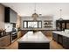Modern kitchen with a large island, stainless steel range, and light wood cabinetry at 7014 E Palo Verde Ln, Paradise Valley, AZ 85253