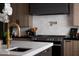 Close up on the kitchen, featuring a pot filler faucet, a gas range, and a white tile backsplash at 7014 E Palo Verde Ln, Paradise Valley, AZ 85253