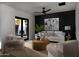 Living room with comfortable seating, modern decor, hardwood floors, and a view of the outdoor fireplace at 7014 E Palo Verde Ln, Paradise Valley, AZ 85253