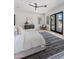 Bright main bedroom with stylish rug and outside access through black framed glass doors at 7014 E Palo Verde Ln, Paradise Valley, AZ 85253