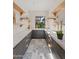 Chic butler's pantry with gray cabinets, open shelving, and views to the outside at 7014 E Palo Verde Ln, Paradise Valley, AZ 85253