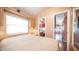 Bedroom with a neutral color palette, ensuite access and a large window for natural light at 834/837 S Beryl/Aquamarine Dr, Apache Junction, AZ 85119