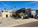 Park model home featuring a large RV with awning at 834/837 S Beryl/Aquamarine Dr, Apache Junction, AZ 85119