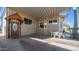 Inviting covered porch featuring a decorative wood door and cozy seating area, perfect for enjoying the outdoors at 834/837 S Beryl/Aquamarine Dr, Apache Junction, AZ 85119