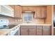 Bright kitchen with modern sink, mauve cabinets and white appliances at 834/837 S Beryl/Aquamarine Dr, Apache Junction, AZ 85119