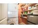 Functional laundry area with stacked washer/dryer and storage shelves at 834/837 S Beryl/Aquamarine Dr, Apache Junction, AZ 85119