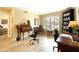 Well-lit home office featuring hardwood floors, shutters, and built-in bookshelves at 9235 N 100Th Pl, Scottsdale, AZ 85258