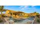 Beautiful backyard featuring a pool, patio, outdoor kitchen, and pergola lounge area, perfect for entertaining and relaxation at 10455 E Thatcher Ave, Mesa, AZ 85212