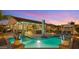 Inviting backyard with pool, outdoor kitchen, covered patio, and desert landscaping at 10455 E Thatcher Ave, Mesa, AZ 85212