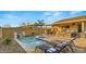 Gorgeous backyard showcases pool, lounge chairs, covered patio with outdoor kitchen, and pergola for ultimate relaxation at 10455 E Thatcher Ave, Mesa, AZ 85212