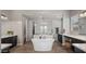 This bright bathroom features a large soaking tub, frameless shower and dual vanity sinks at 10455 E Thatcher Ave, Mesa, AZ 85212