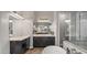 Bright bathroom features a double sink vanity, soaking tub, frameless shower and large mirror at 10455 E Thatcher Ave, Mesa, AZ 85212