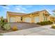 Home exterior showcases a three-car garage, well-manicured landscaping, and a neutral color palette at 10455 E Thatcher Ave, Mesa, AZ 85212