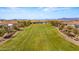 Expansive front lawn with mature trees and a view of the community center in a well-maintained neighborhood at 10455 E Thatcher Ave, Mesa, AZ 85212