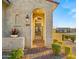 Inviting front porch and entryway featuring desert landscaping, a gate, and warm lighting at 10455 E Thatcher Ave, Mesa, AZ 85212