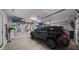 Well-organized garage, with a parked car, featuring ample storage solutions with a clean, epoxy floor at 10455 E Thatcher Ave, Mesa, AZ 85212