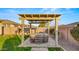 Inviting backyard pergola with hot tub and lush landscaping for serene outdoor living and relaxation at 10455 E Thatcher Ave, Mesa, AZ 85212