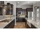 Close up on a beautifully appointed kitchen featuring a large island, stainless steel appliances, and mosaic backsplash at 10455 E Thatcher Ave, Mesa, AZ 85212