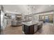 Open floor plan with a stylish kitchen island, comfortable seating, and a wood-accented entertainment center at 10455 E Thatcher Ave, Mesa, AZ 85212