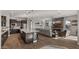 Open-concept living area featuring a modern kitchen, cozy seating, and stylish fireplace with a wood accent wall at 10455 E Thatcher Ave, Mesa, AZ 85212
