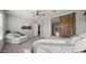 This expansive main bedroom features an adjacent sitting area, ensuite bath and a large sliding barn door at 10455 E Thatcher Ave, Mesa, AZ 85212