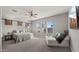The bright main bedroom features an adjacent sitting area, plush carpet and a modern ceiling fan at 10455 E Thatcher Ave, Mesa, AZ 85212