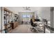 Inviting home office with bookshelves, ample natural light, and contemporary furnishings for a productive workspace at 10455 E Thatcher Ave, Mesa, AZ 85212